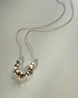 gold and silver faceted bead necklace on silver chain