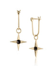 Gold earrings with star-shaped design and inverted black diamond on a white background