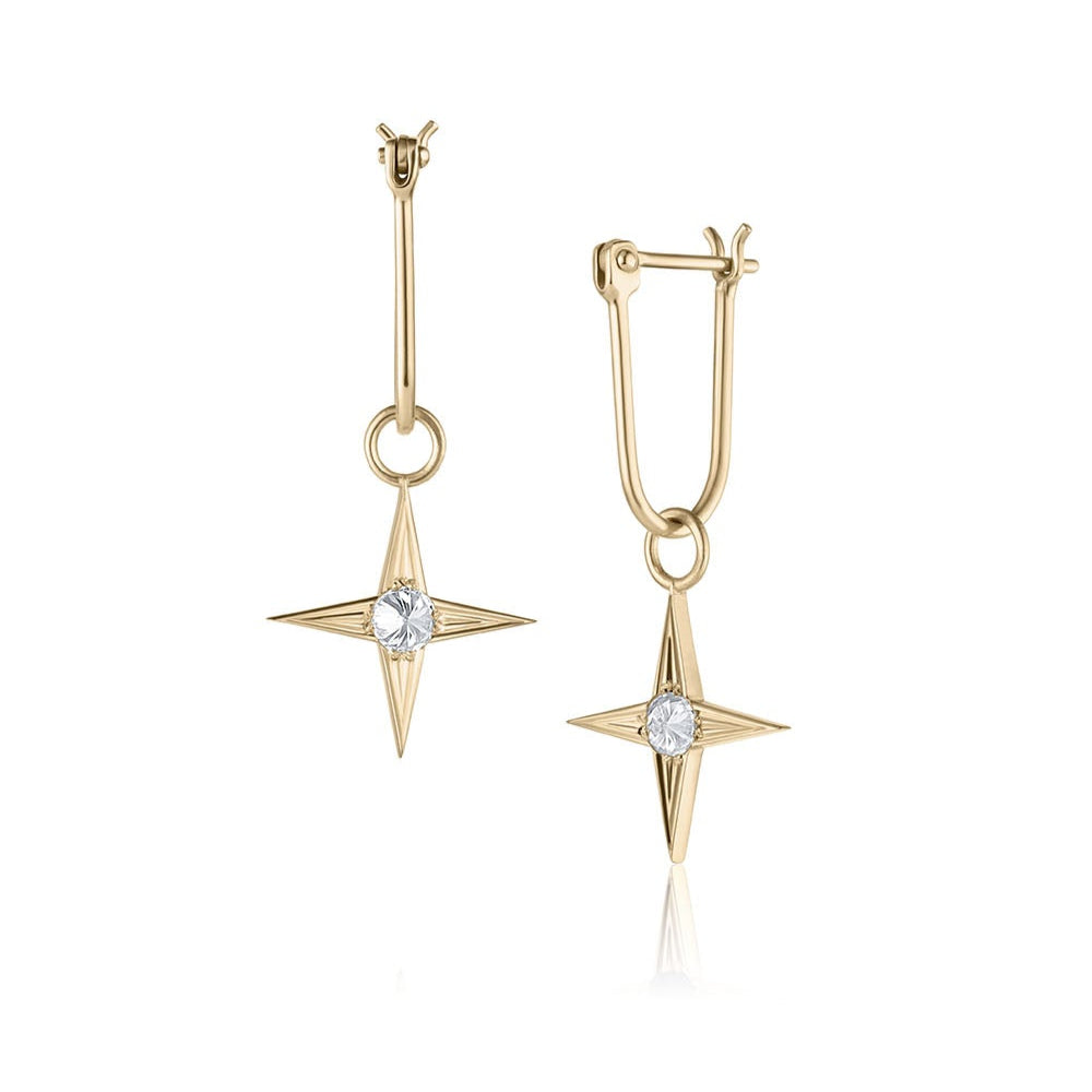 Gold star-shaped earrings with inverted white diamonds on a white background