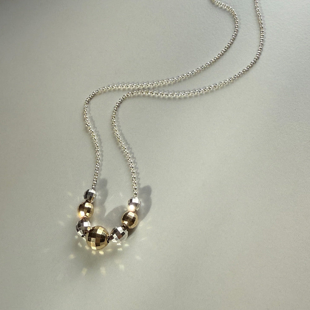 gold and silver faceted bead necklace on silver chain