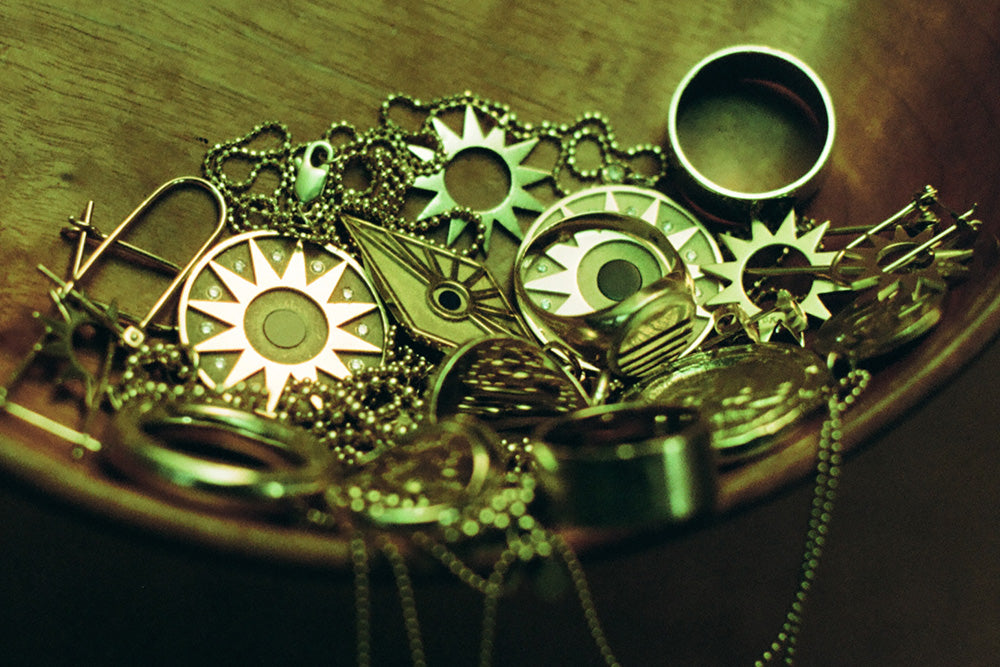 Gold jewelry with various designs on a wooden surface