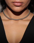 silver bead necklace on woman wearing black tank